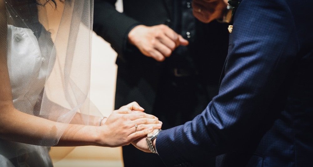 A Couple Getting Married Holding Hands