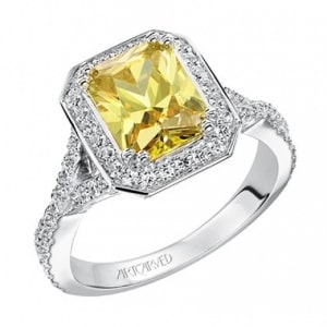 a halo engagement ring with an emerald-cut yellow diamond center stone.