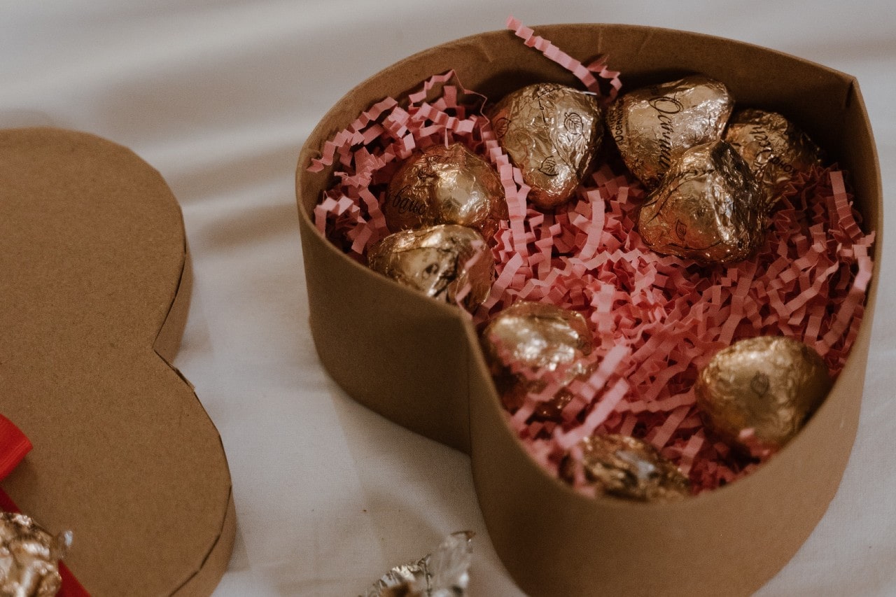 A heart-shaped box with chocolates inside