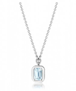 A bezel set topaz necklace on a white gold chain.