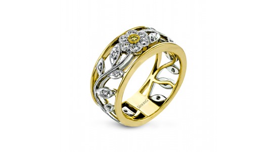 a mixed metal fashion ring with floral motifs and diamond accents