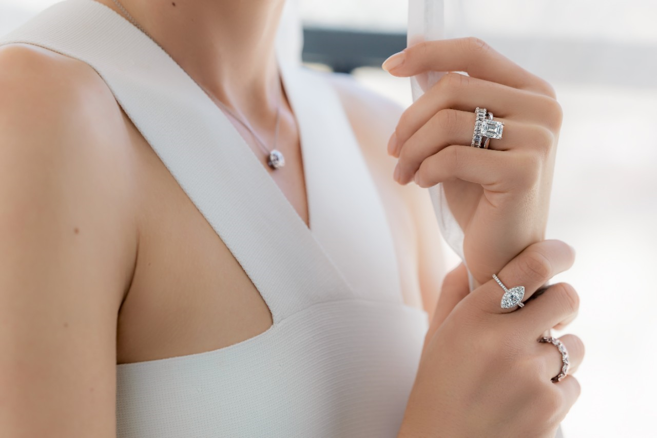 A lady wearing various engagement rings