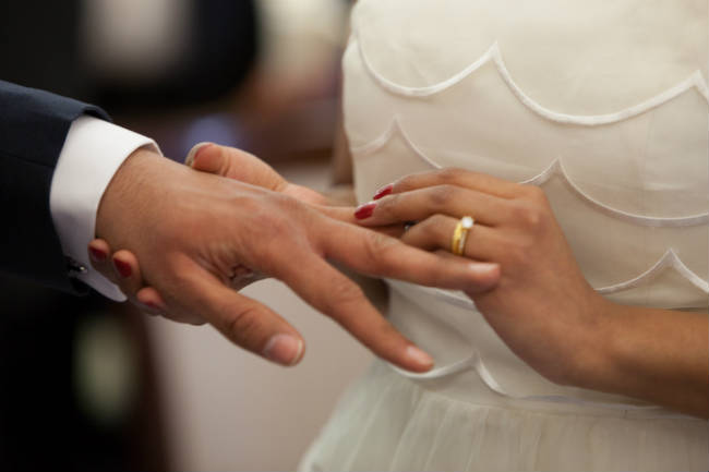 Placing Wedding Band on Hand