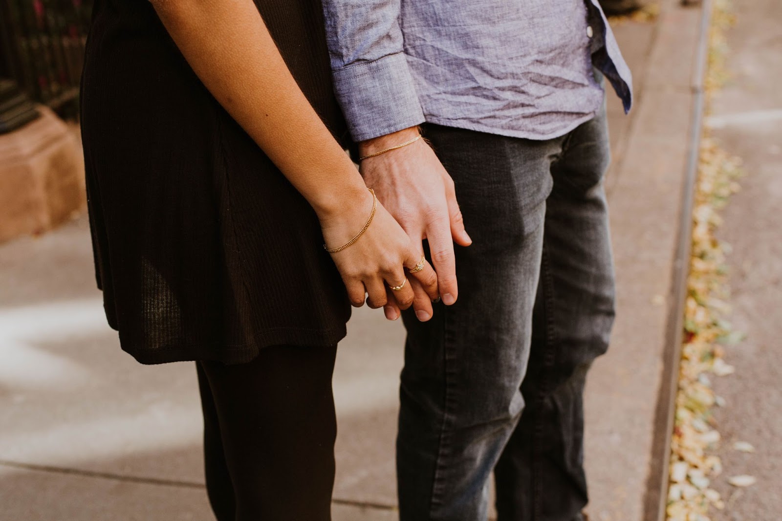 A Couple Holding Hands With Rings