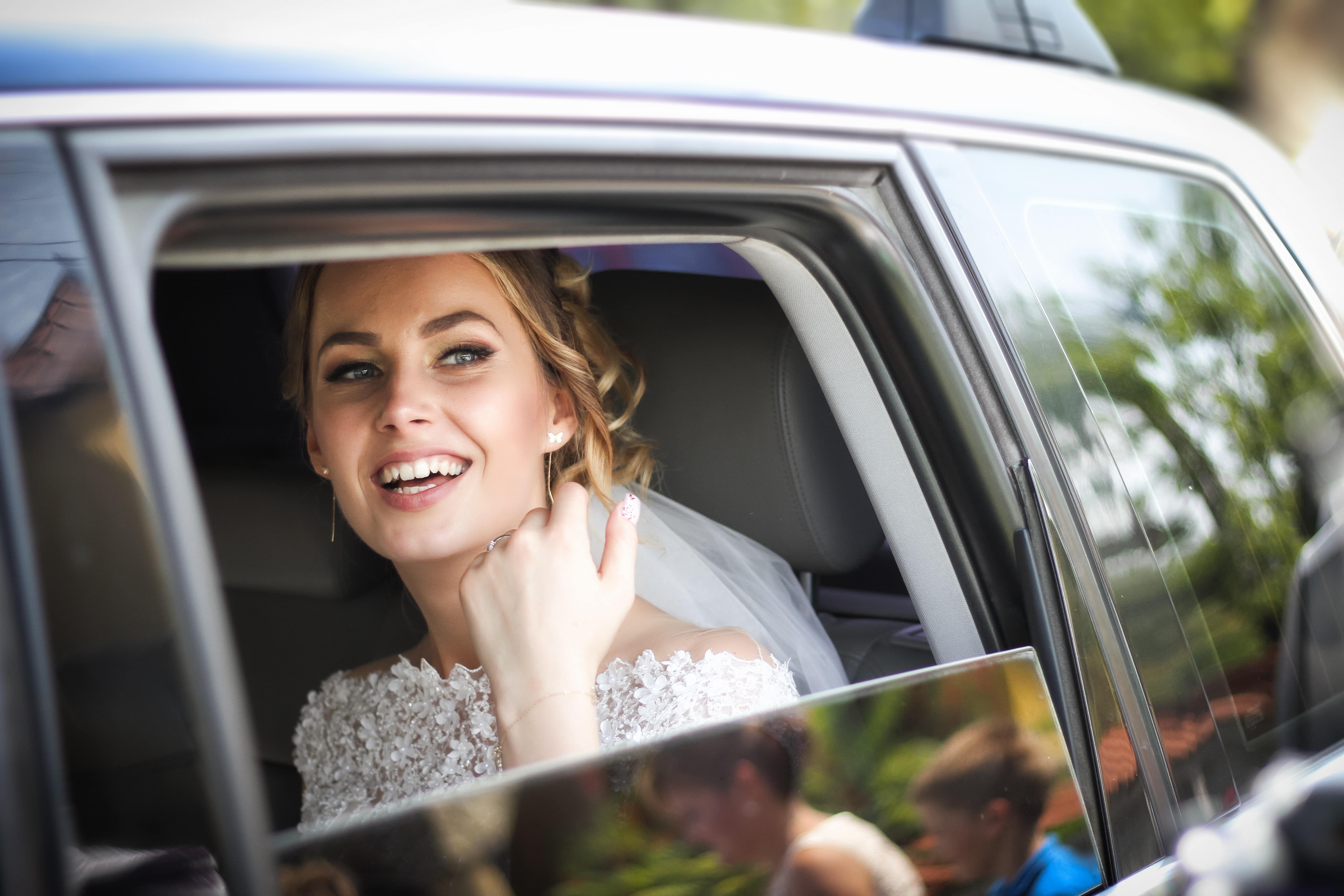 A Woman Sitting In a Car with the Window Down A Woman Sitting In a Car with the Window Down