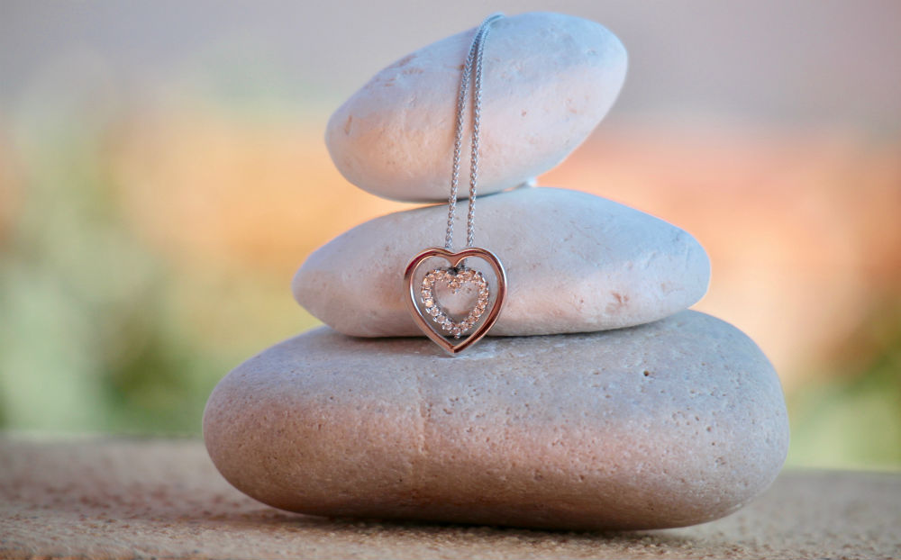 A Picture of a Necklace on Top of Stones A Picture of a Necklace on Top of Stones