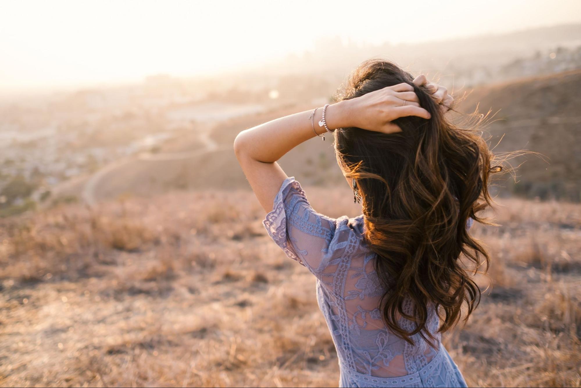 lady standing in the sunlight wearing a diamond bracelet