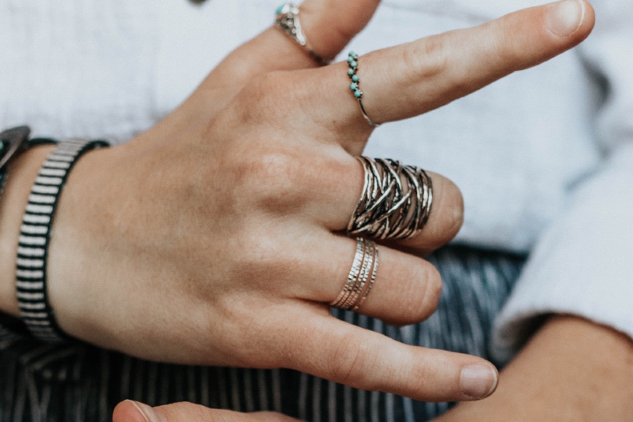 A woman sports multiple sterling silver fashion rings A woman sports multiple sterling silver fashion rings